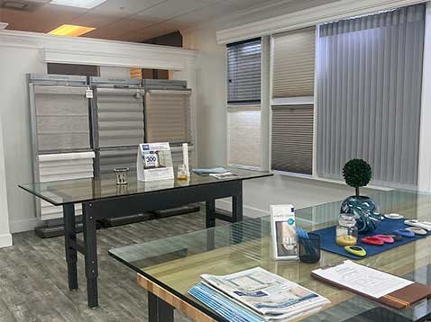 Store interior showcasing several different types of window coverings